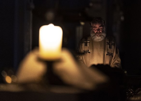 Pastor Klemens Armbruster reads from the Bible during the Easter Vigil Service in the monastery church, St. Peter, Germany. Due to the coronavirus pandemic, the Easter Vigil services are held without an audience.