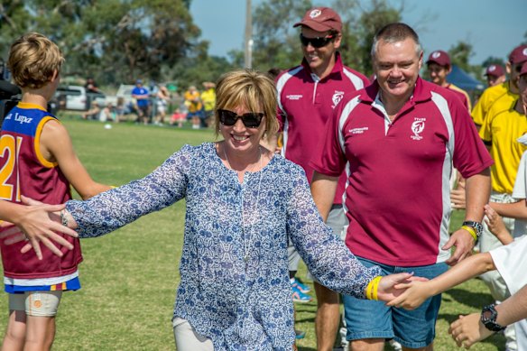 Rosie Batty leads the teams out on Tyabb Oval through a guard of honour at the Luke Batty Tribute Match in Tyabb. 