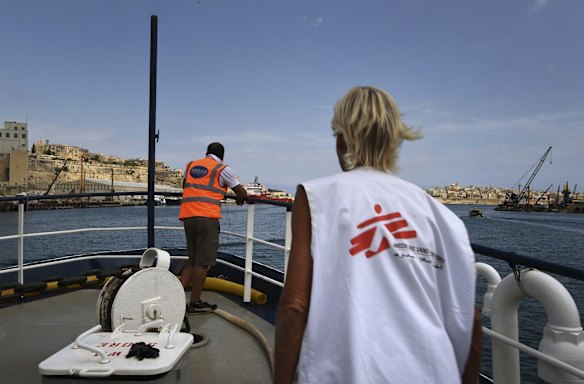 A crew member for Migrant Offshore Aid Station (MOAS) and Mary Jo Fawley (right) a nurse with Medecins Sans Frontieres (MSF) watch the city of Valletta pass by on the upperdeck of the MY Phoenix, a rescue boat operated by MOAS with the support of MSF as it sails out of the Grand Harbour in Malta to the search and rescue zone where they will rescue refugees that are attempting to cross from Libya to Europe.