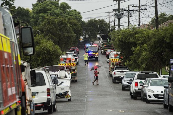 Numerous fire crews and emergency services assess the damage during a storm in Chester Hill.