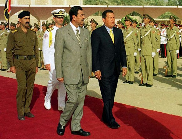 In this Aug. 11, 2000 file photo, Venezuela's President Hugo Chavez, front right, walks with Iraqi's President Saddam Hussein at Saddam airport in Baghdad, Iraq. Chavez, the first national leader to visit Iraq since the Gulf War in 1991, was leaving the country after a short visit as part of a tour of OPEC countries.