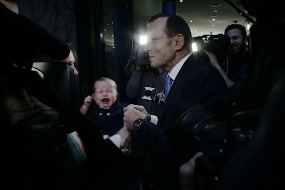 Opposition Leader Tony Abbott meets 4 month old Sybil Taylor during a visit to a cafe in Malvern, Victoria.
