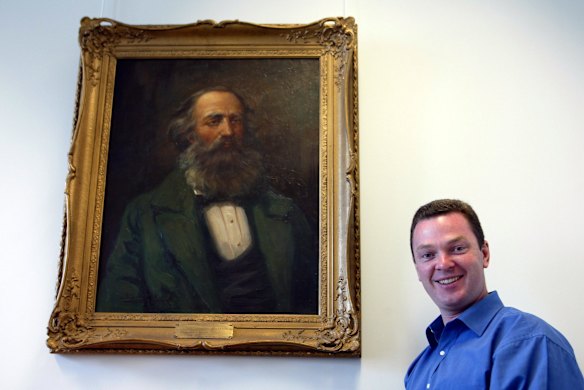 Christopher Pyne, Liberal Member for Sturt, SA with a painting in his office in Parliament House Canberra. Monday the 4th of August 2003. 