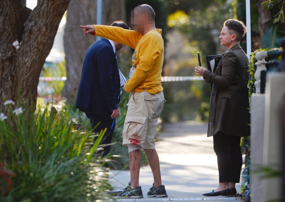 Police talk to a man bearing wounds from a violent assault on Wigram Road on Thursday. 