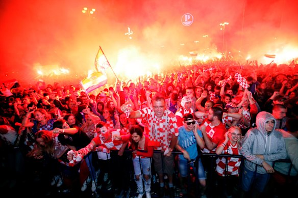 Croatian fans cheer while watching the semifinal match between Croatia and England at the 2018 soccer World Cup, in Zagreb, Croatia.