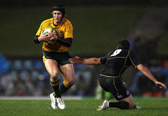 Berrick Barnes of Australia is tackled during the International Test match between the Australian Wallabies and Scotland at Hunter Stadium on June 5, 2012 in Newcastle, Australia.