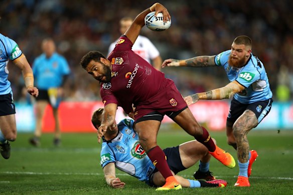 Sam Thaiday of the Maroons is tackled.