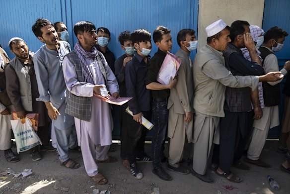 Afghans wait in long lines for hours at the passport office as many are desperate to have their travel documents ready to go on August 14, 2021 in Kabul, Afghanistan. Tensions are high as the Taliban advance on the capital city after taking the major cities of Herat, Mazar-e Sharif, and the country's second-largest city Kandahar.