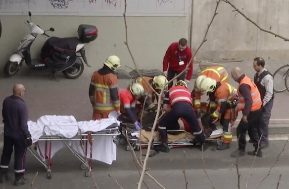 In this image made from video, emergency rescue workers stretcher an unidentified person at the site of an explosion at a metro station in Brussels. Explosions rocked the Brussels airport and the subway system.