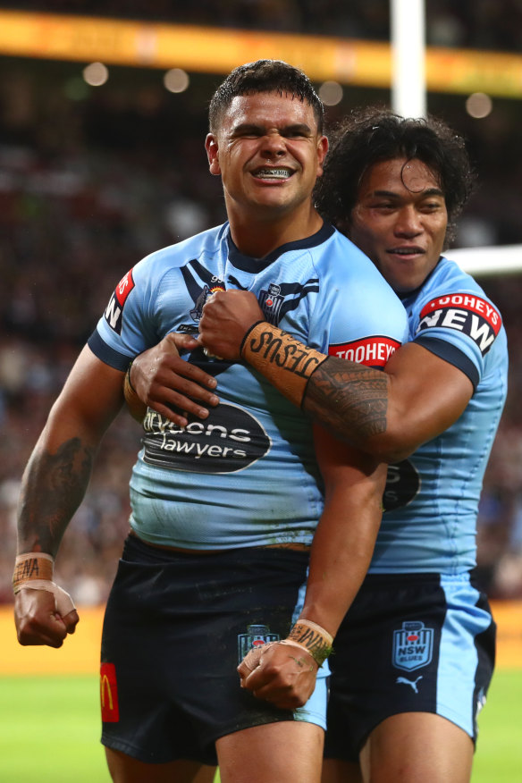 Latrell Mitchell celebrates his try on Sunday night.