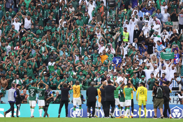 Saudi Arabia players celebrate with their fans.