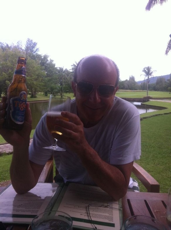 Mr Ballintine enjoying a beer at a resort in Phuket.