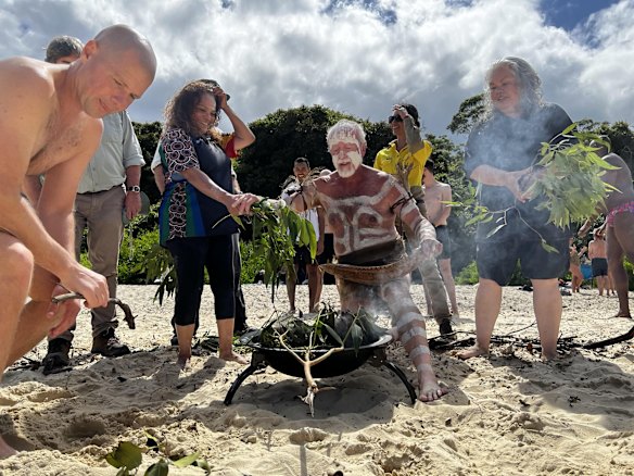 Local Indigenous people perform an inclusion smoking ceremony at Collins Flat Reserve in Manly.