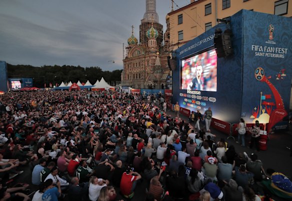 People watch a broadcast of the semifinal match between Croatia and England at the 2018 soccer World Cup at a fan zone in St.Petersburg, Russia.