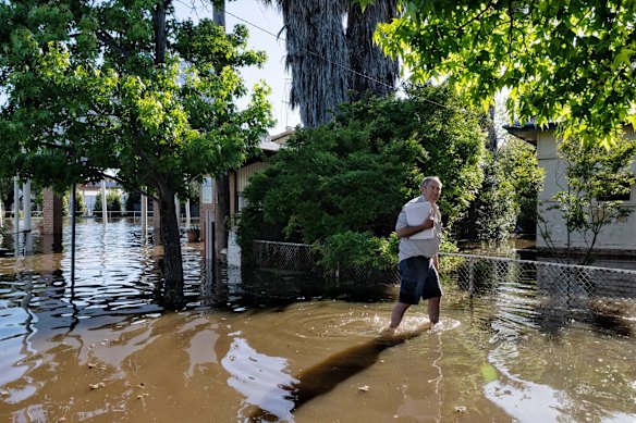 Local business owner Steve Lewis retrieves documents from his flooded business, Friday November 4, 2022.