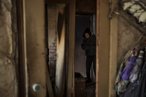 A woman walks inside her heavily damaged apartment in Kyiv after it was bombed. World leaders pushed for an investigation of the Kremlin's repeated attacks on civilian targets, including schools, hospitals and residential areas.