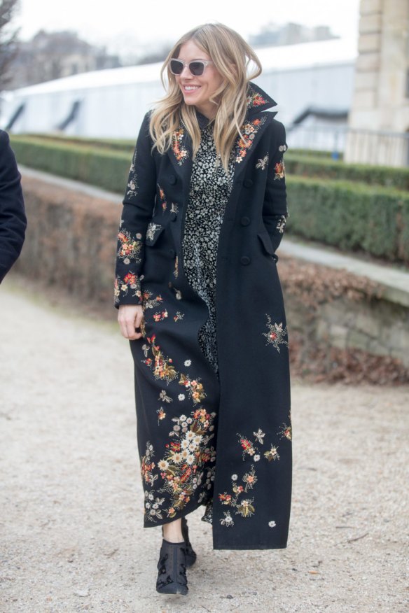 On her coat tails ... Sienna Miller wraps herself in florals in Paris.