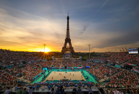 The sun sets on the beach volleyball competition beneath the Eiffel Tower.