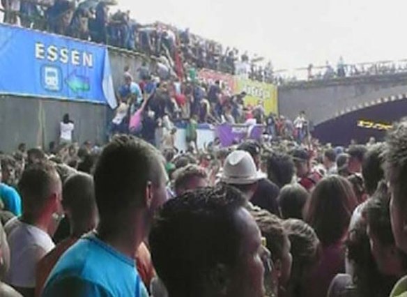 In this image taken from television people are seen trying to escape over a wall by the tunnel entrance after a panic on this year's Love Parade 2010" in Duisburg, Germany.