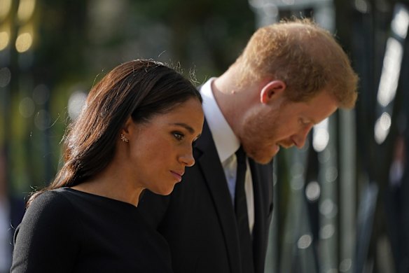 Britain's Prince Harry and Meghan, Duchess of Sussex view the floral tributes for the late Queen Elizabeth II outside Windsor Castle.
