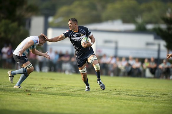 Brumbies' Rory Arnold fends off a Waratahs opponent. 