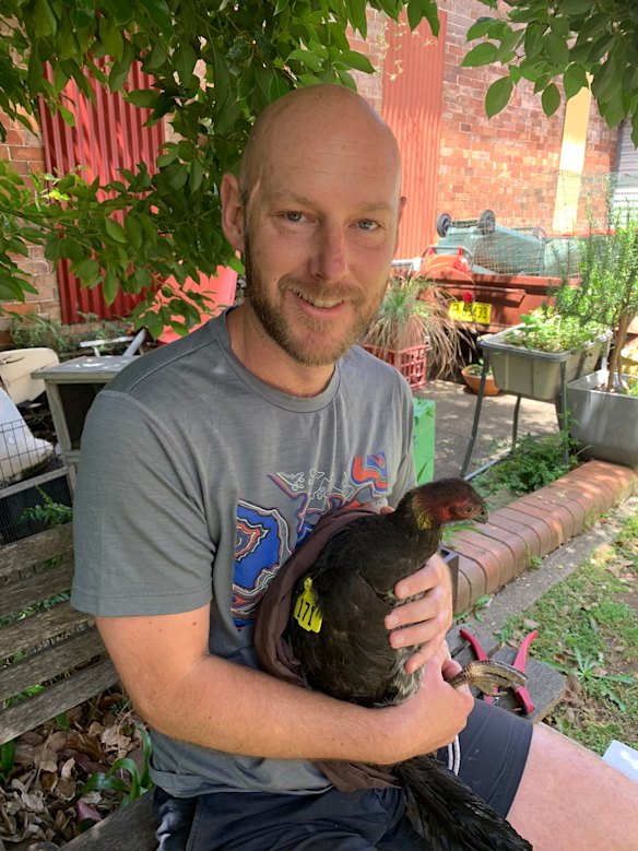 Dr John Martin with a brush turkey in his backyard in Annandale in 2018.
