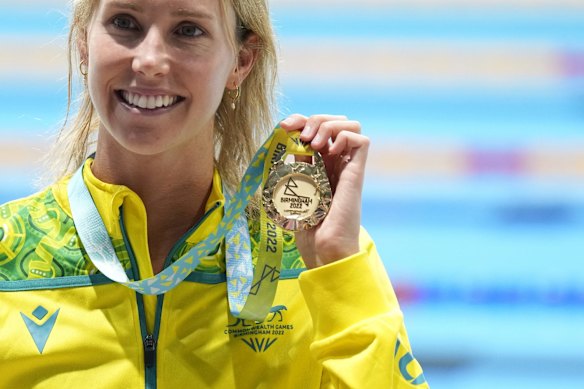 Emma McKeon of Australia poses after winning the gold medal in the Women's 50 meters butterfly final.