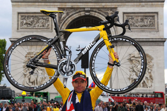 Momentous: Australia's Cadel Evans lifts his bike in front of the Arc de Triomphe after finally winning the Tour de France.