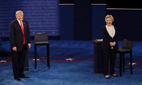 Republican presidential nominee Donald Trump and Democratic presidential nominee Hillary Clinton react to a question.