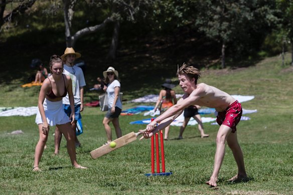 Kids play cricket in the park in Bronte.