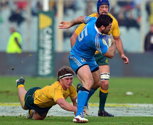 Italy's fullback Andrea Masi is tackled by Michael Hooper.