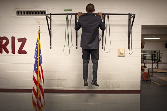 Before this photo is taken, two staffers pass the bar and do two pull-ups each. Not to be outdone, Obama does three with ease, then walks out to make a speech.