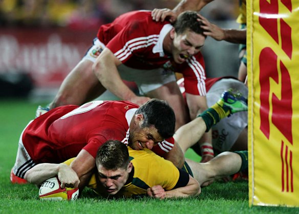 James O' Connor plants the ball over the line to score.