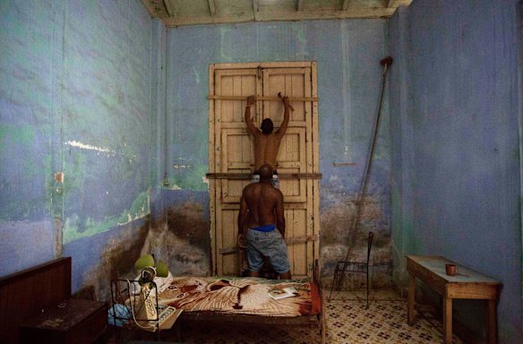 Men board up a door in preparation for Hurricane Irma in Caibarien, Cuba.