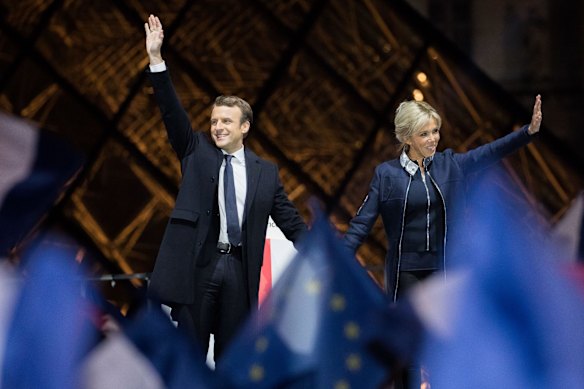 Emmanuel Macron, French presidential candidate, and his wife wife Brigitte Trogneux, wave after delivering a speech in front of the Pyramid at the Louvre Museum in Paris.