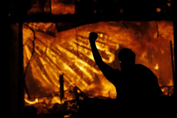 Protesters gather outside the burning Minneapolis police 3rd Precinct building.
