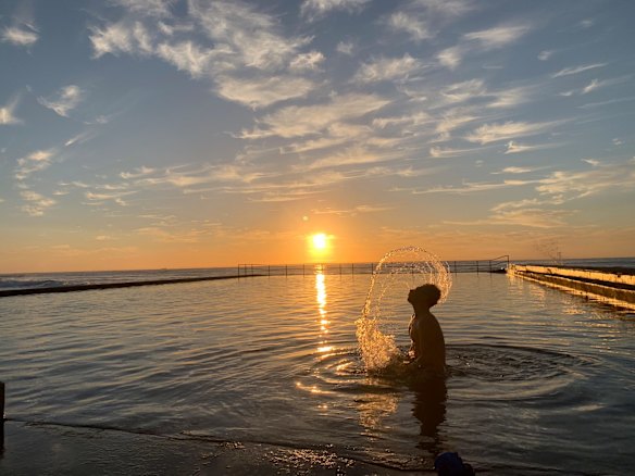 An early morning swimmer at Austinmer beach in Wollongong. Photo taken at sunrise.