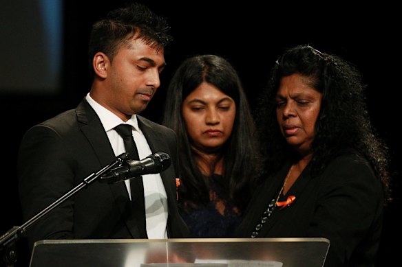 Chinthu Sukumaran (left) speaks during his brother's funeral service.