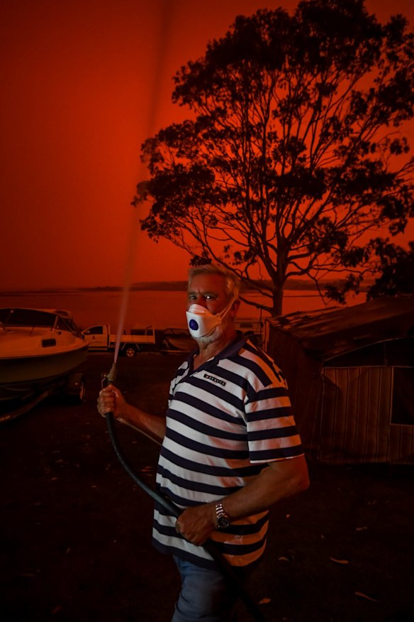 John Edwards hosing down his caravan.