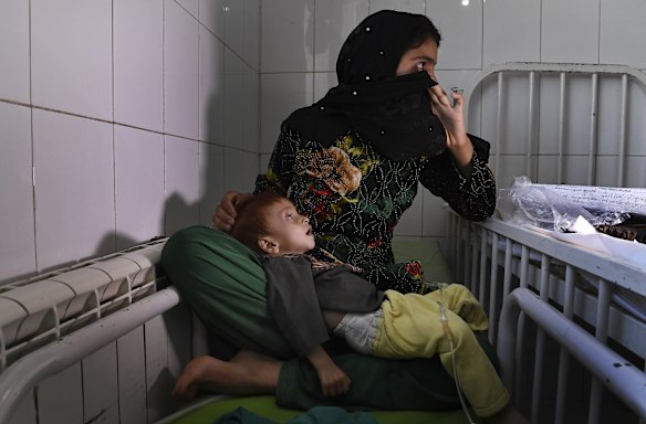 Saber aged 10 months old suffering from severe acute malnutrition is comforted by his mother Shahr Banoo aged 15 years whilst being treated at the Mofleh Pediatric Hospital in Shaidayee area outside Herat city.