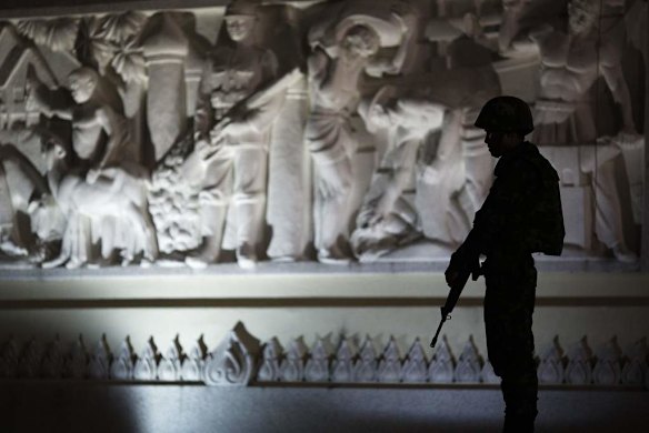 A soldier takes up position at the Democracy monument in Bangkok.