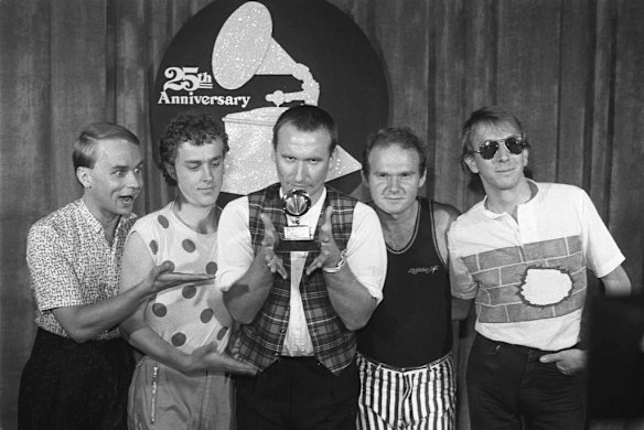 "Men at Work," from left, Greg Ham, Ron Strykert, Colin Hay, Jerry Speiser and John Rees, pose with their Grammy for best new artist at the awards show in Los Angeles in 1983. Photo by AP