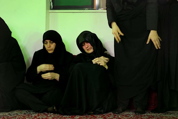 The sister of killed asylum seeker Reza Barati, Kowsar, centre, is supported with her grief by her aunts and other family members during the memorial service.