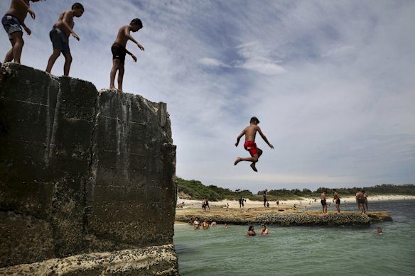 Crowds find refuge from the oppressive heat, swimming at Yarra Bay.