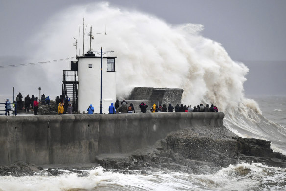 Waves and rough seas pound against the harbour wall at Porthcawl in Wales.