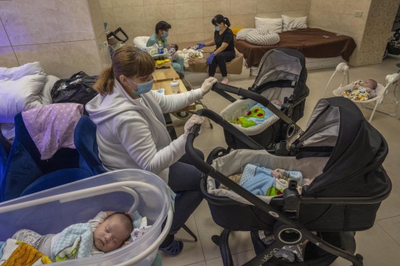 Nannies take care of newborn babies in a basement converted into a nursery in Kyiv.