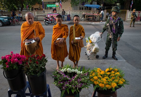 Buddhist Monks are guarded by armed Thai soldiers on their morning rounds collecting alms. They are often targeted and have been injured and killed in the 10 years of insurgency in the southern border provinces. 