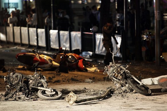 Burnt motorcycles lie strewn across the street following an explosion at the Ratchaprasong intersection in Bangkok, Thailand, on Monday, Aug. 17, 2015. 