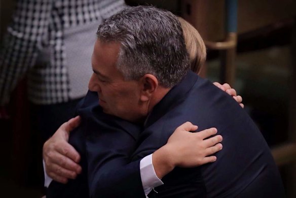 Treasurer Joe Hockey is hugged by his 8 year old son Xavier after he delivered his first budget.