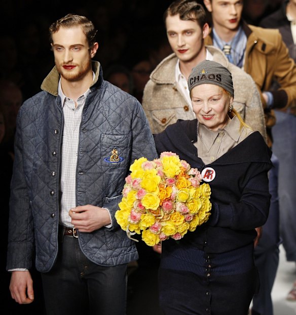British designer Vivienne Westwood, right, smiles on the catwalk at the end of the presentation of her men's Fall-Winter 2011/2012 collection show, part of the Milan Fashion Week, unveiled in Milan, Italy, Sunday, Jan. 16, 2011. 